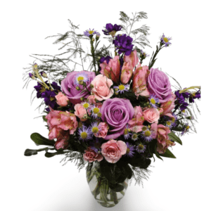 Purple and pink rose bouquet in vase.