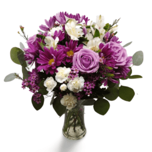 Purple flower arrangement in glass vase.